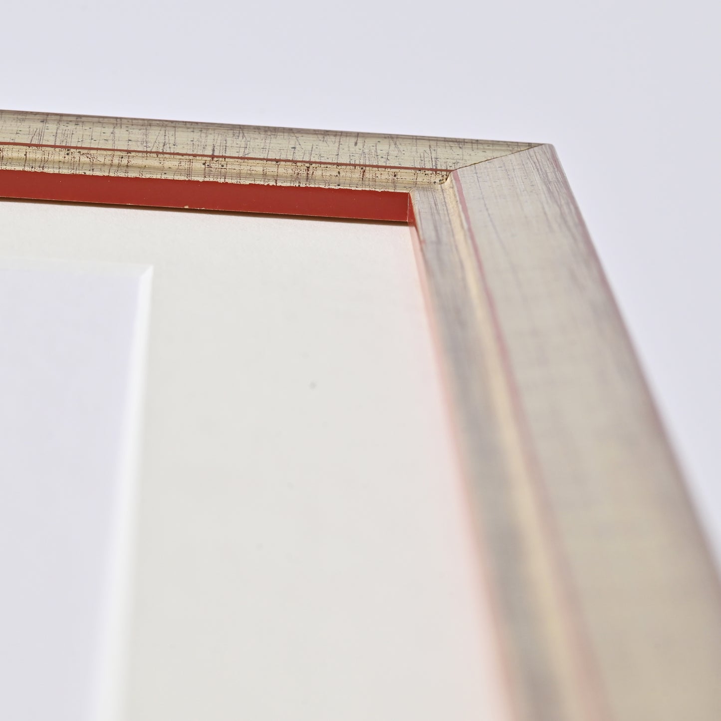 1" Wide Brushed Silver Foil With Distressed Red Undertones On Angled Profile