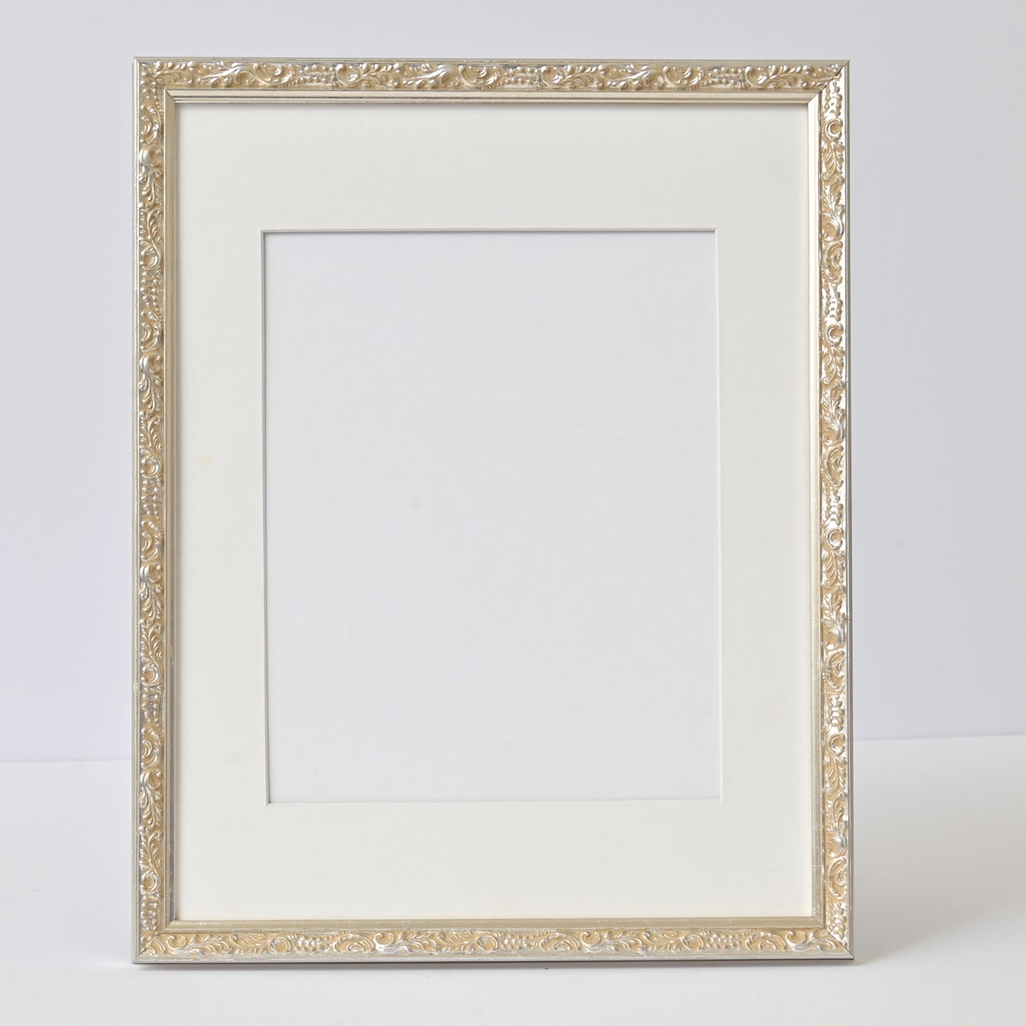 Ornate Bright Silver Gilded Frame On Ornate Motif Pattern