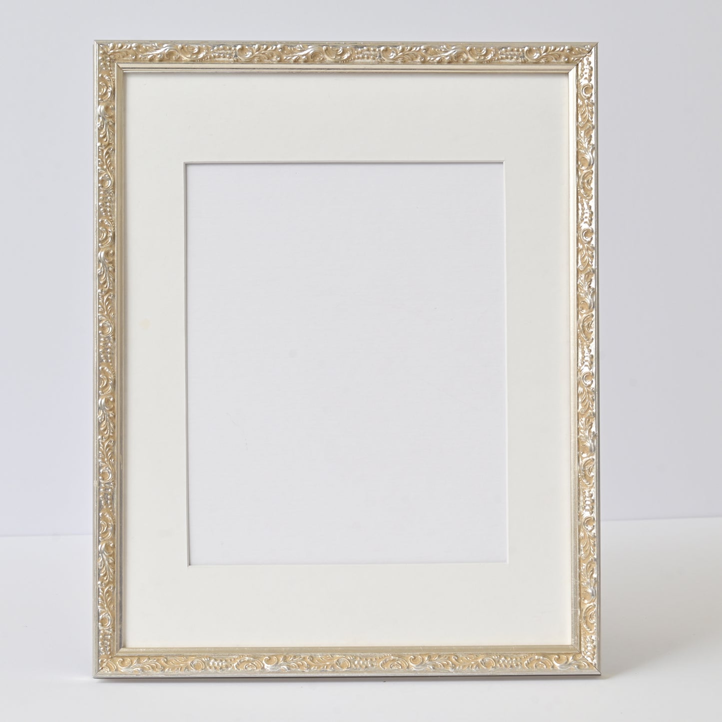 Ornate Bright Silver Gilded Frame On Ornate Motif Pattern